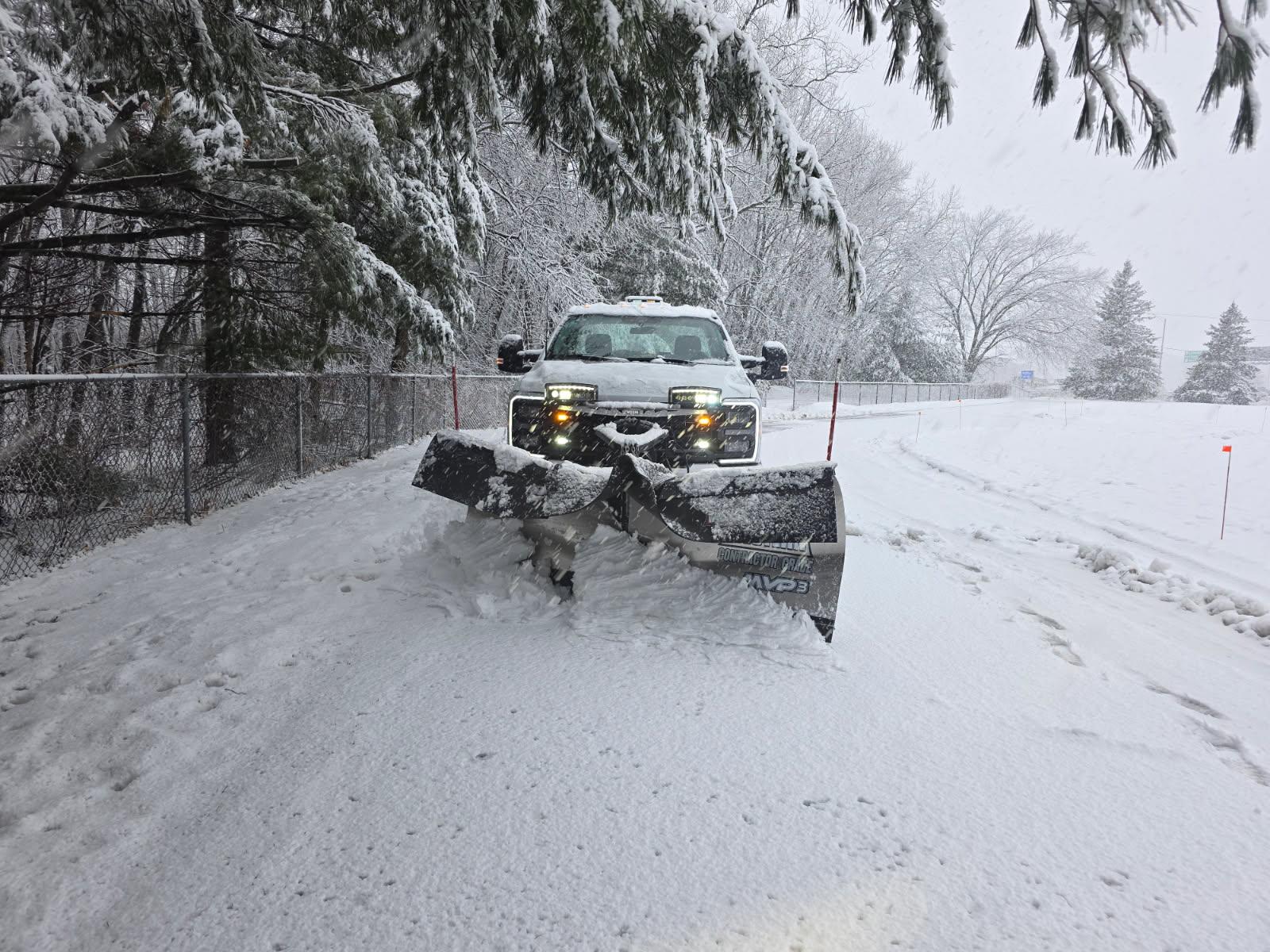 Snow removal process with plow truck and crew